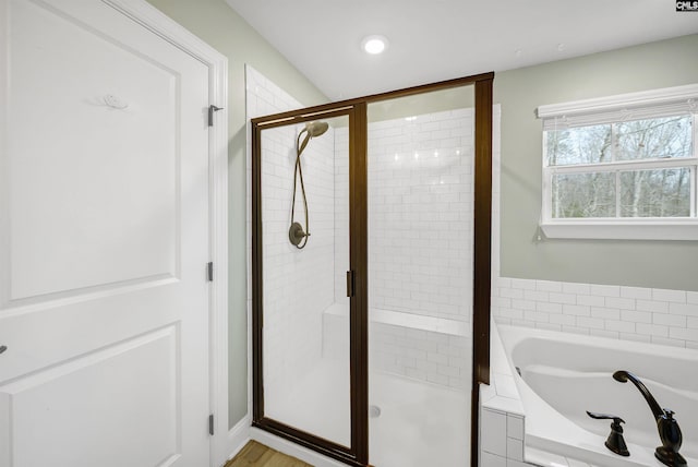 full bathroom featuring a bath, recessed lighting, and a stall shower