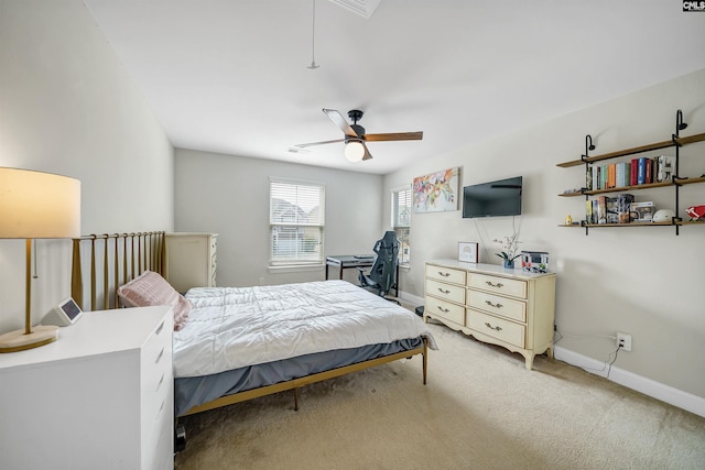 bedroom featuring light carpet, ceiling fan, attic access, and baseboards