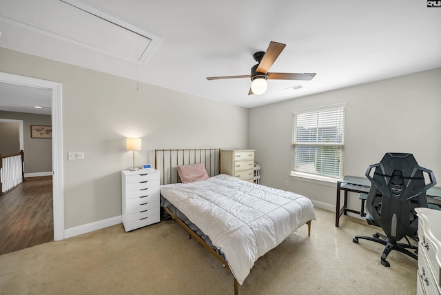 bedroom with baseboards, visible vents, carpet floors, attic access, and ceiling fan