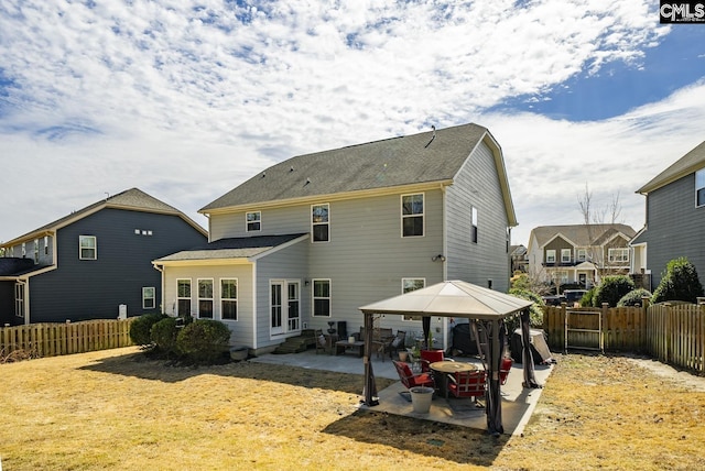 rear view of house featuring a gazebo, entry steps, fence private yard, and a patio