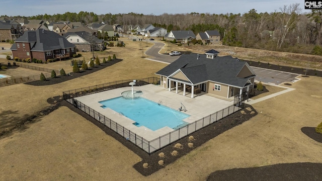 view of swimming pool with a fenced in pool, a water slide, fence, a residential view, and a patio area