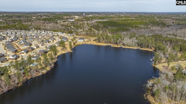 drone / aerial view with a forest view and a water view