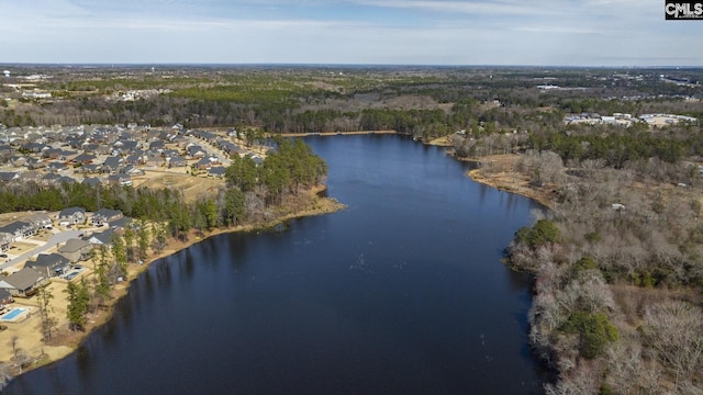 birds eye view of property featuring a forest view and a water view