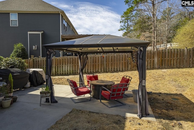 view of patio / terrace featuring a gazebo, grilling area, a fire pit, and a fenced backyard