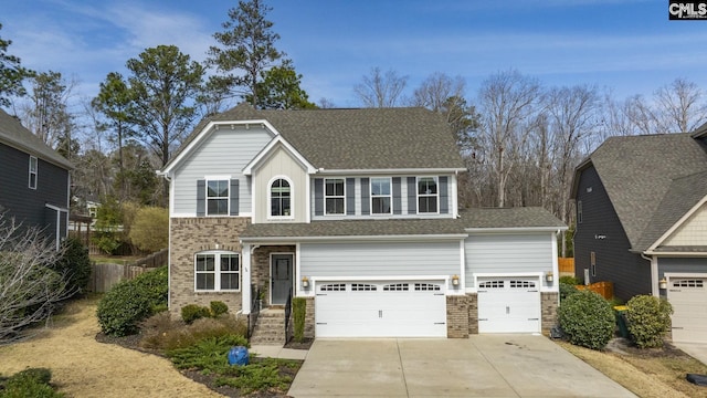 view of front of house featuring fence, brick siding, driveway, and a shingled roof