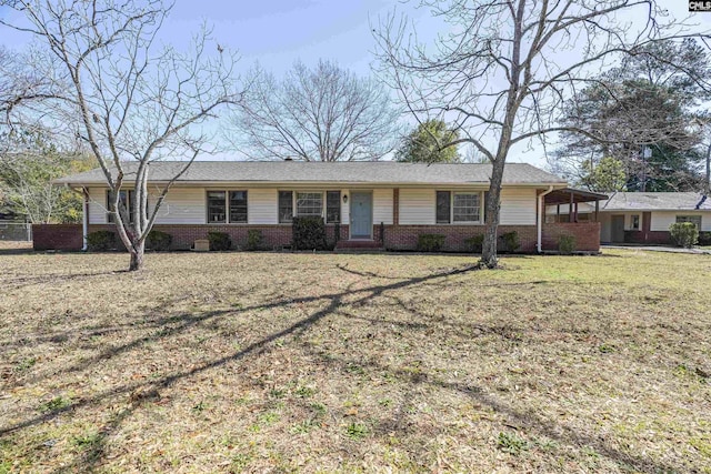 ranch-style house featuring brick siding and a front lawn