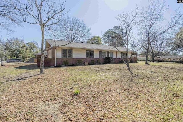 single story home with a front yard and brick siding