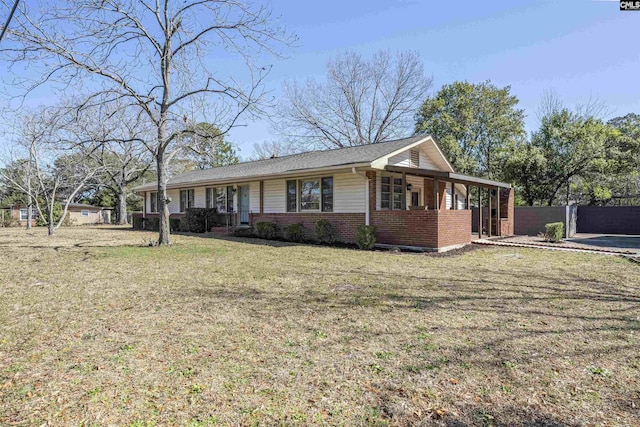 single story home with brick siding, a front lawn, and fence