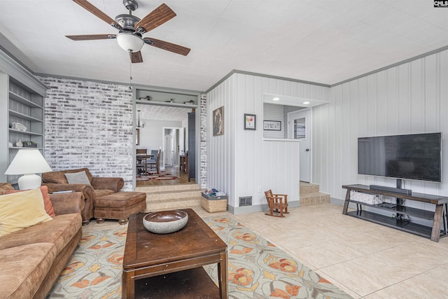 living room featuring stairs, visible vents, a ceiling fan, and tile patterned flooring