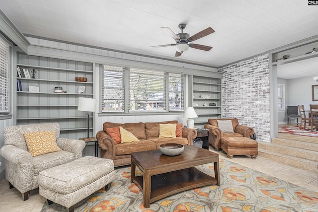 tiled living area featuring built in features, plenty of natural light, and ceiling fan