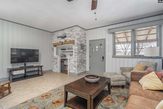 living area with tile patterned flooring and ceiling fan