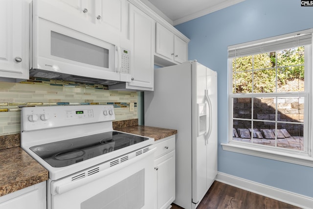 kitchen with white cabinetry, white appliances, dark countertops, and ornamental molding