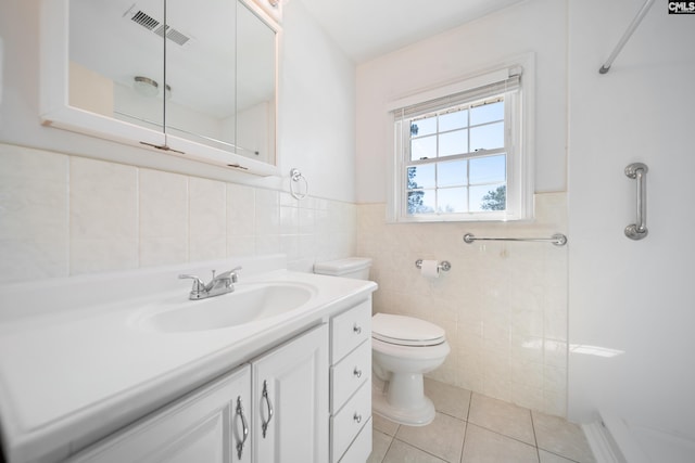 full bathroom with tile patterned flooring, visible vents, toilet, vanity, and a shower