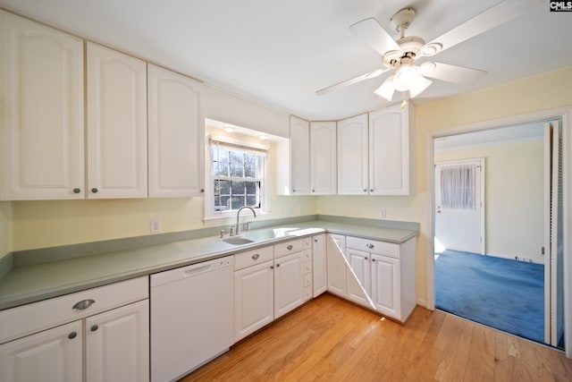 kitchen with a sink, white cabinetry, white dishwasher, and light wood finished floors