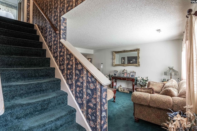 stairs featuring visible vents, a textured ceiling, and carpet floors