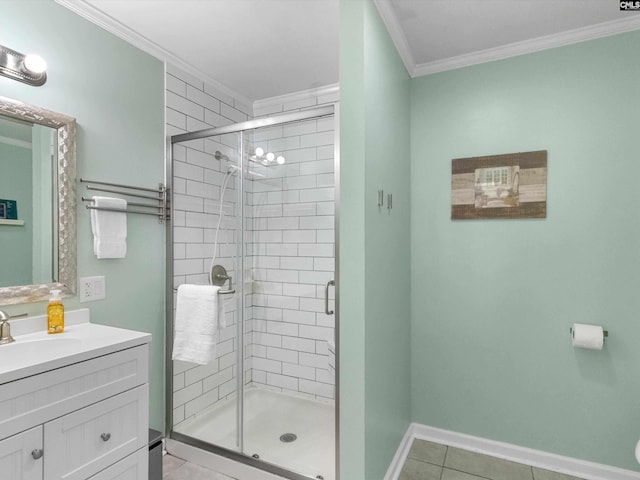 bathroom featuring vanity, baseboards, a stall shower, tile patterned flooring, and crown molding