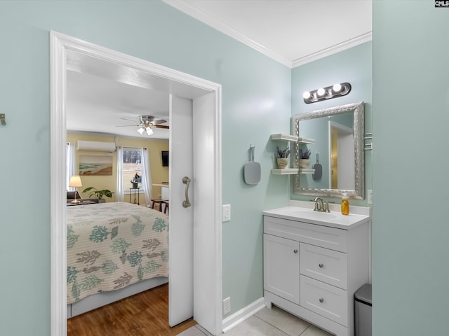 ensuite bathroom featuring crown molding, baseboards, ensuite bathroom, vanity, and a ceiling fan