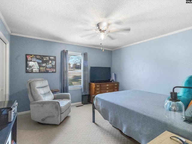 carpeted bedroom with baseboards, a textured ceiling, ceiling fan, and crown molding