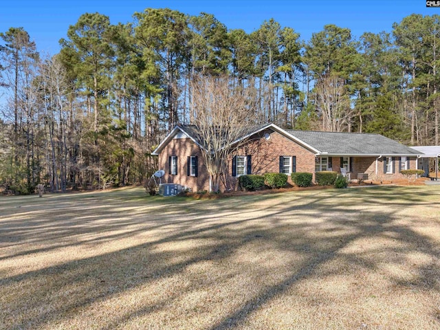 view of front of home with brick siding, central air condition unit, and a front yard