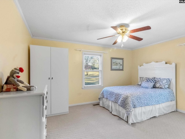 bedroom with ceiling fan, baseboards, light colored carpet, ornamental molding, and a textured ceiling