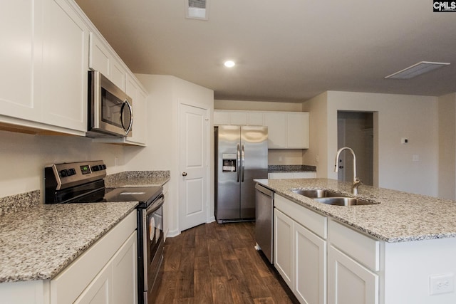 kitchen with visible vents, dark wood-type flooring, white cabinets, stainless steel appliances, and a sink