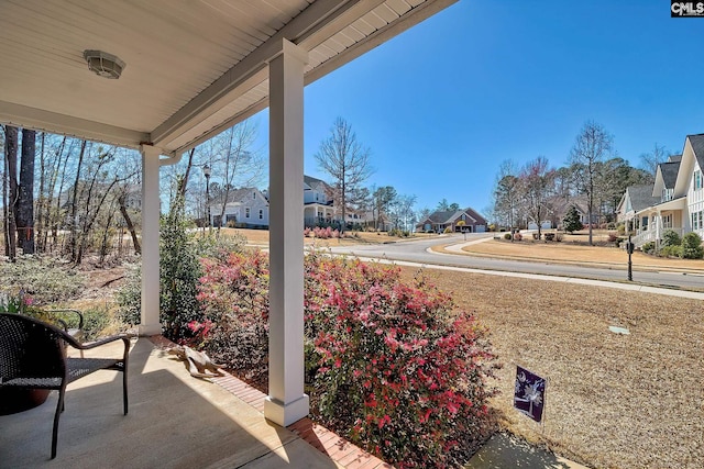 view of patio with a residential view and a porch