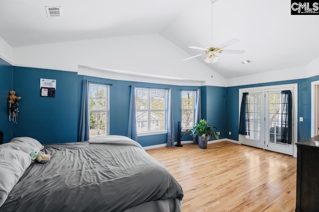 bedroom with visible vents, access to outside, light wood-style floors, ceiling fan, and vaulted ceiling