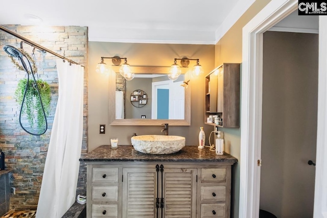 bathroom featuring vanity and tiled shower