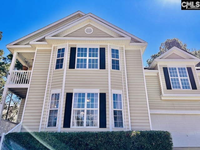 view of side of home with a balcony