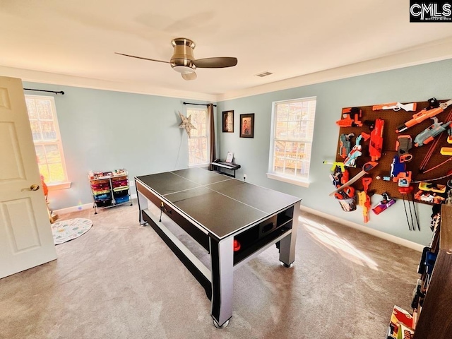 recreation room with carpet flooring, baseboards, visible vents, and ceiling fan