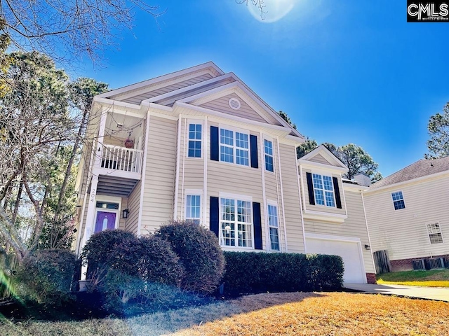 view of front of property with a garage and a balcony