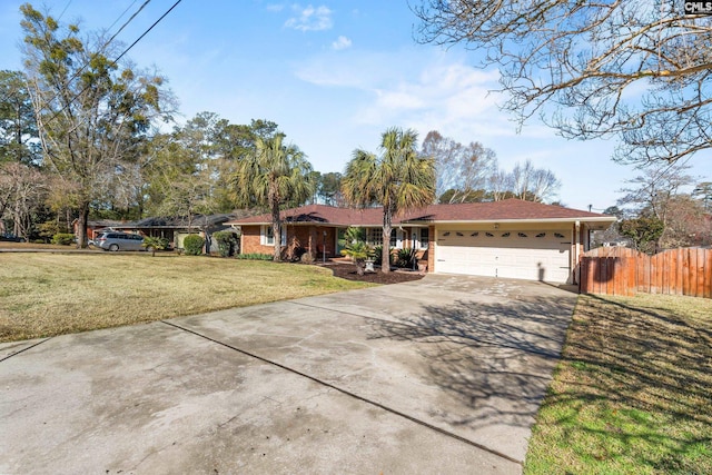 single story home featuring brick siding, a front lawn, fence, a garage, and driveway