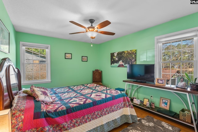 bedroom featuring wood finished floors and ceiling fan