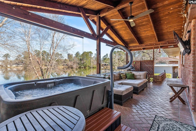 view of patio / terrace featuring an outdoor living space, a hot tub, and a ceiling fan