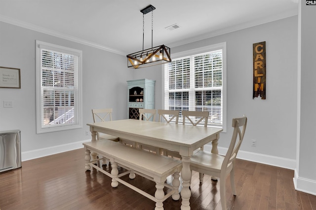 dining space with visible vents, baseboards, dark wood-style flooring, ornamental molding, and a chandelier