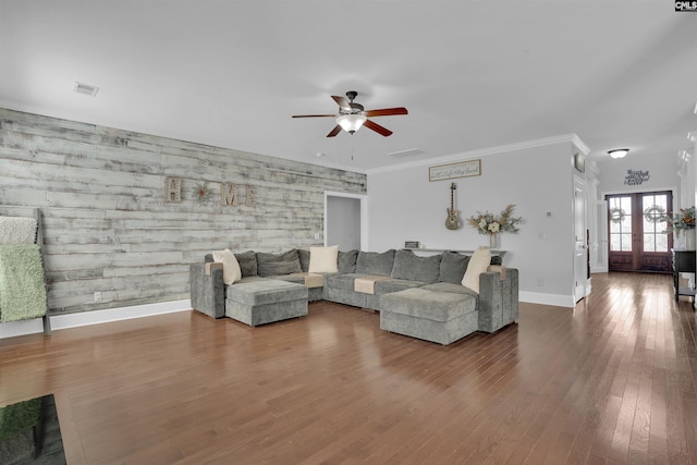 living area with visible vents, wood finished floors, french doors, crown molding, and baseboards