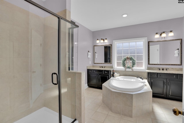 bathroom featuring a shower stall, a bath, tile patterned floors, and a sink