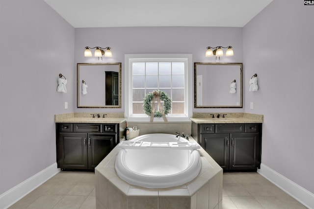 bathroom featuring a sink, baseboards, and two vanities