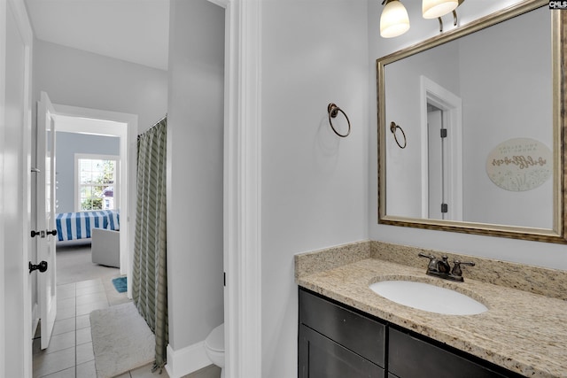 full bathroom featuring vanity, toilet, and tile patterned flooring