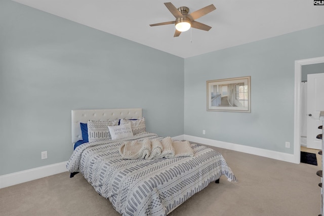 carpeted bedroom featuring baseboards and a ceiling fan