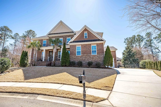 craftsman-style home with brick siding and concrete driveway