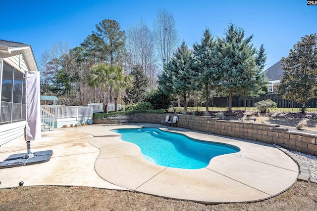 view of pool featuring a patio, a fenced backyard, a fenced in pool, and a sunroom