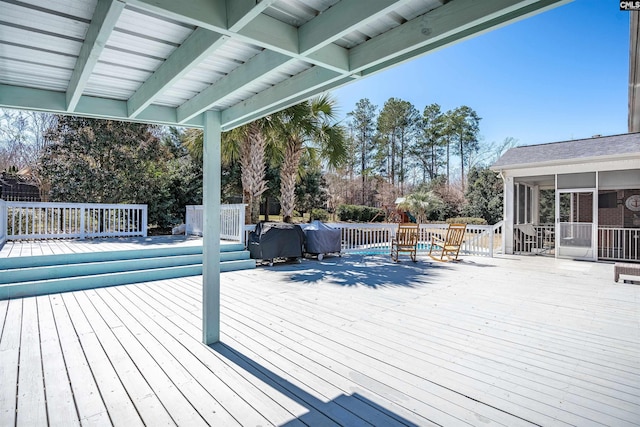 wooden deck featuring a sunroom