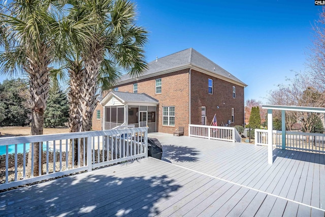 wooden deck with a sunroom