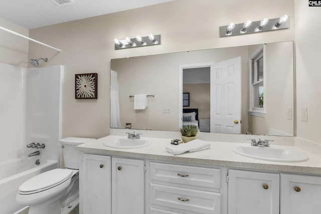 full bathroom with a sink, shower / tub combo, toilet, and double vanity