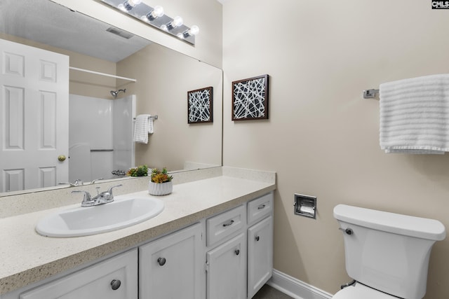 full bathroom with visible vents, toilet, a shower, baseboards, and vanity