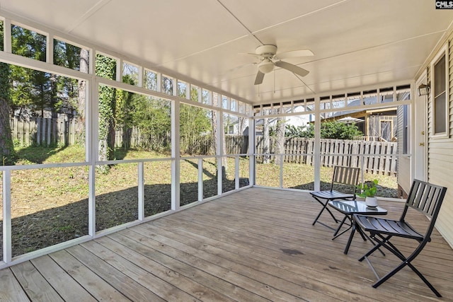 unfurnished sunroom featuring a ceiling fan