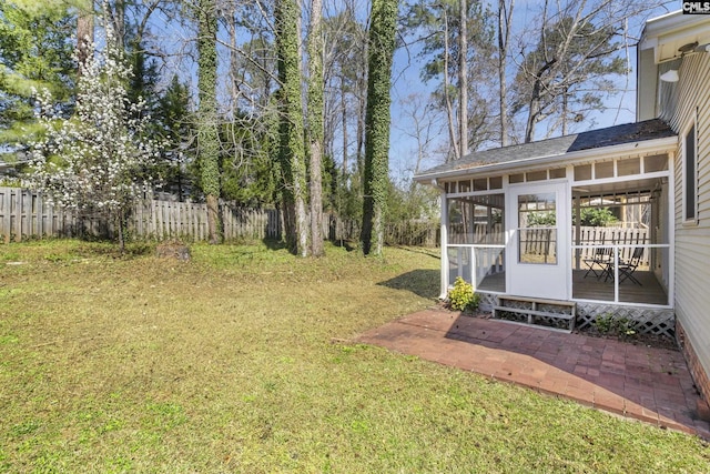 view of yard featuring fence and a sunroom