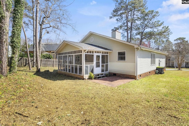 rear view of house with fence, a yard, a sunroom, crawl space, and a chimney