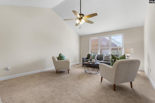 sitting room with ceiling fan, high vaulted ceiling, baseboards, and light carpet